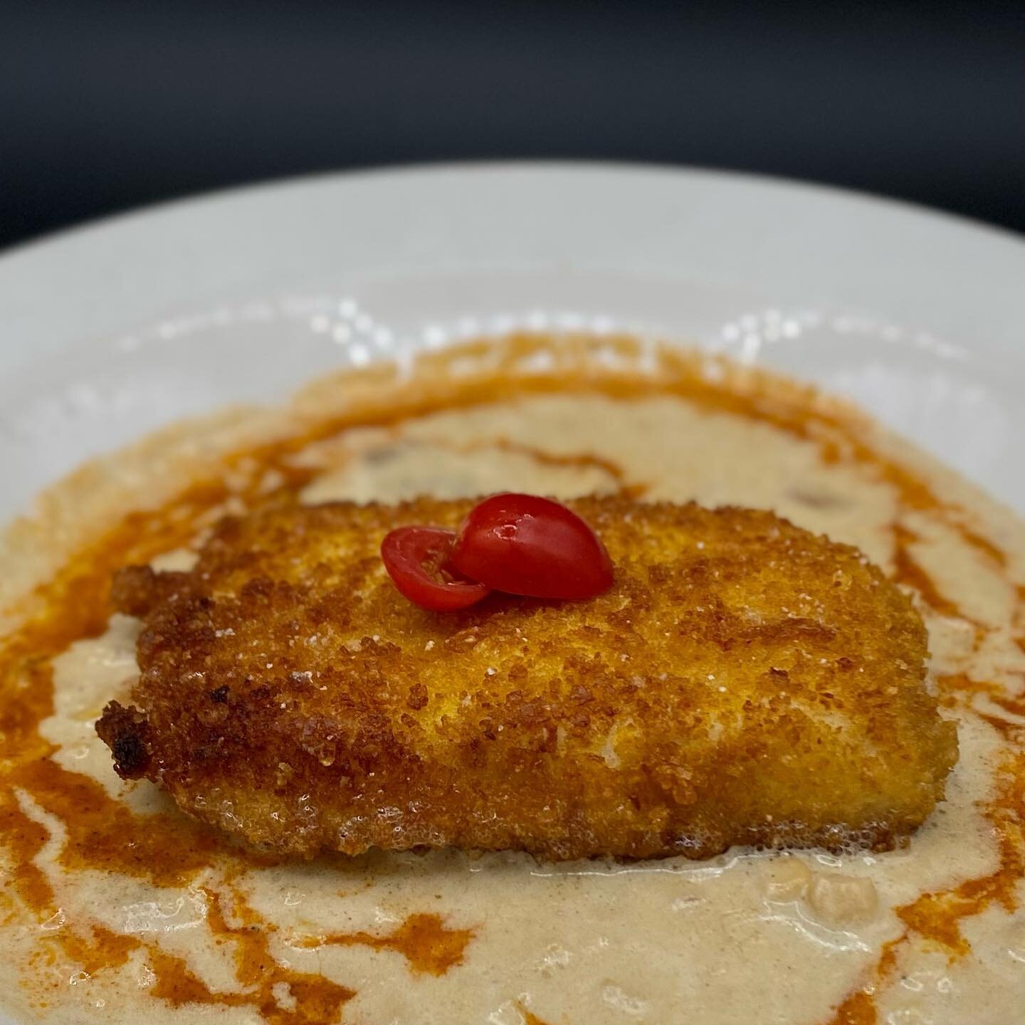 It's what's on the inside that counts, right? 

When you break through this delicate cornflake crust, you'll find the softest and flakiest halibut you've ever tasted. Served atop smoked corn chowder that&rsquo;s been drizzled with grilled tomato oil 