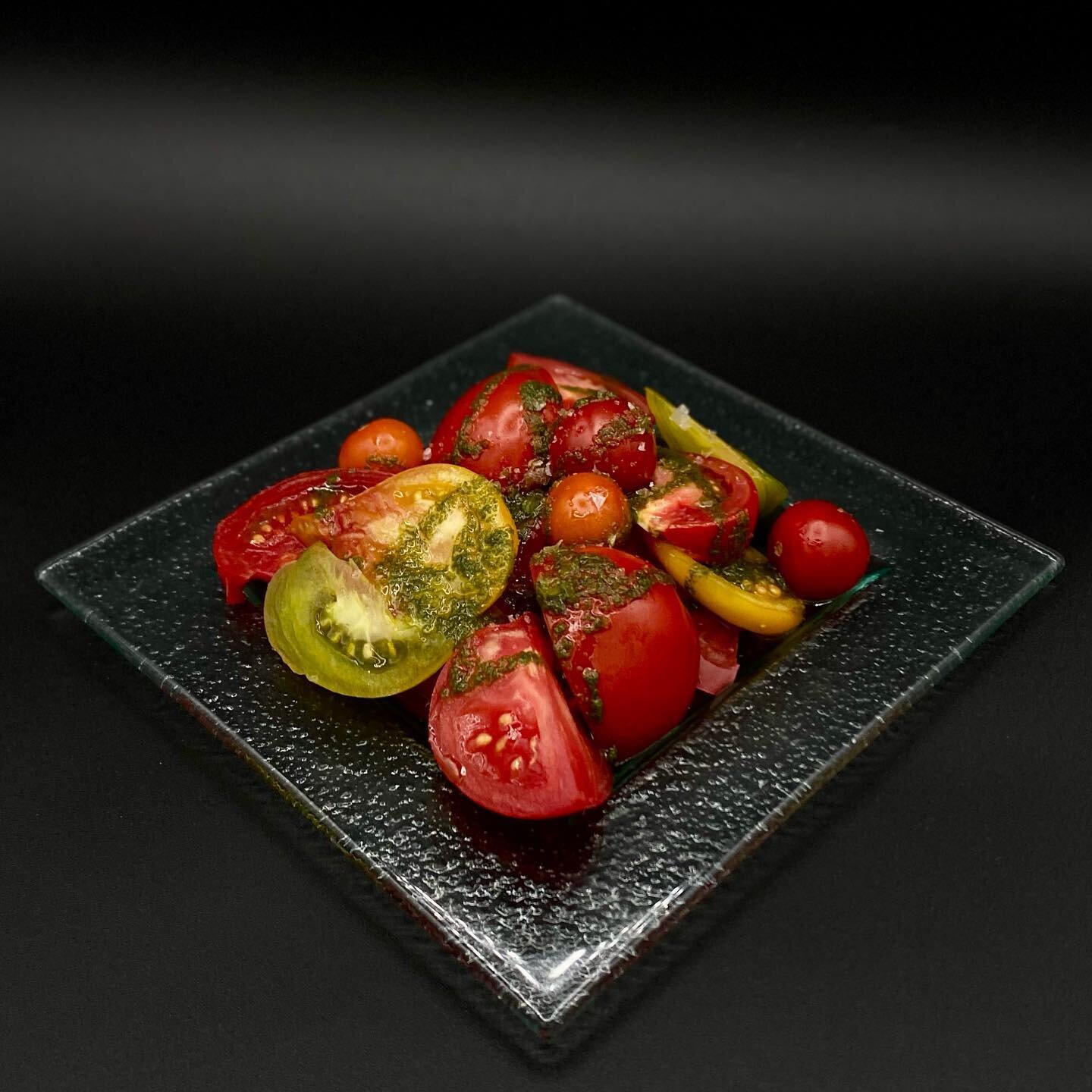 Forever a favorite &mdash; and for good reason! Our Tomato Sampler features a bouquet of brightly sweet tomatoes from Sunrise Organic Farm that have been drizzled with our house-made basil oil and Lustau sherry vinegar, which has been aged for 30 yea