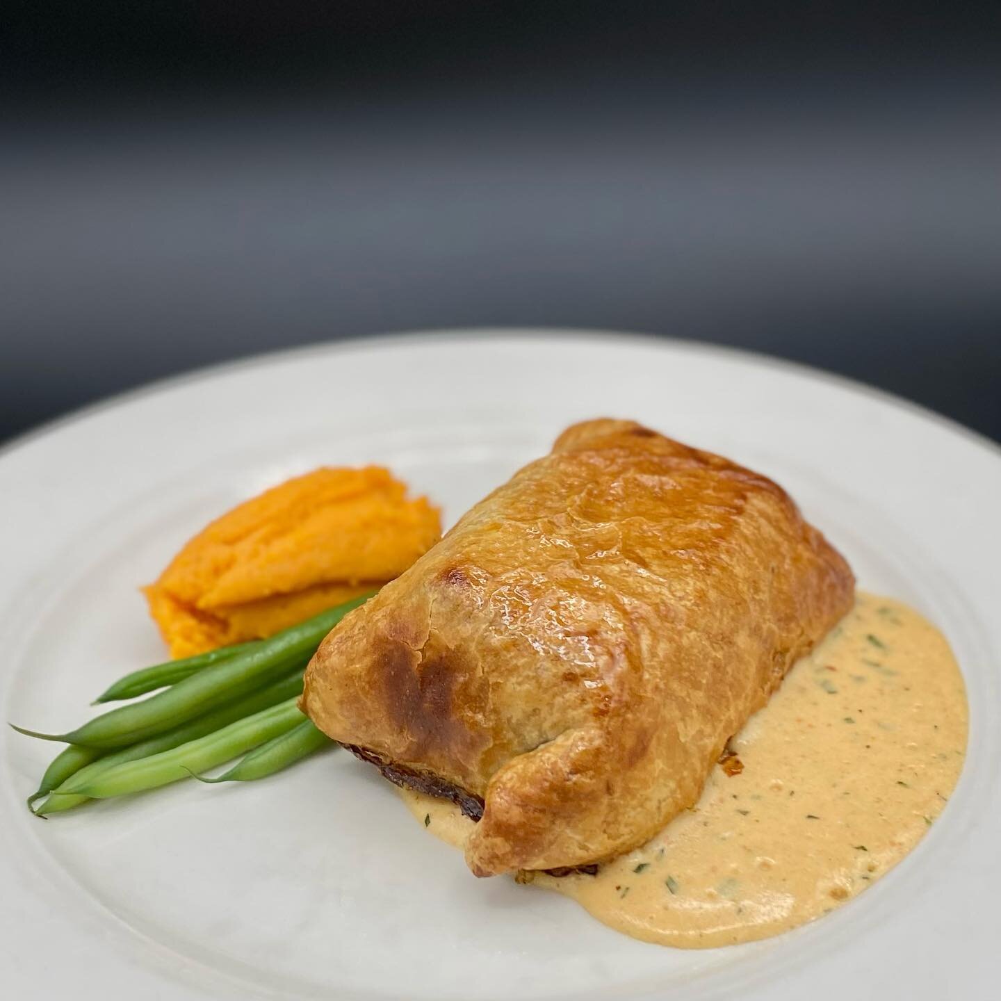 A throwback from his early years in the kitchen, our special tonight features Wild Chinook Salmon, Spinach, and Maine Lobster Mousse inside our warm and flaky house-made Puff Pastry. Accompanied by Tomato B&eacute;arnaise, Green Beans, and Sweet Pota