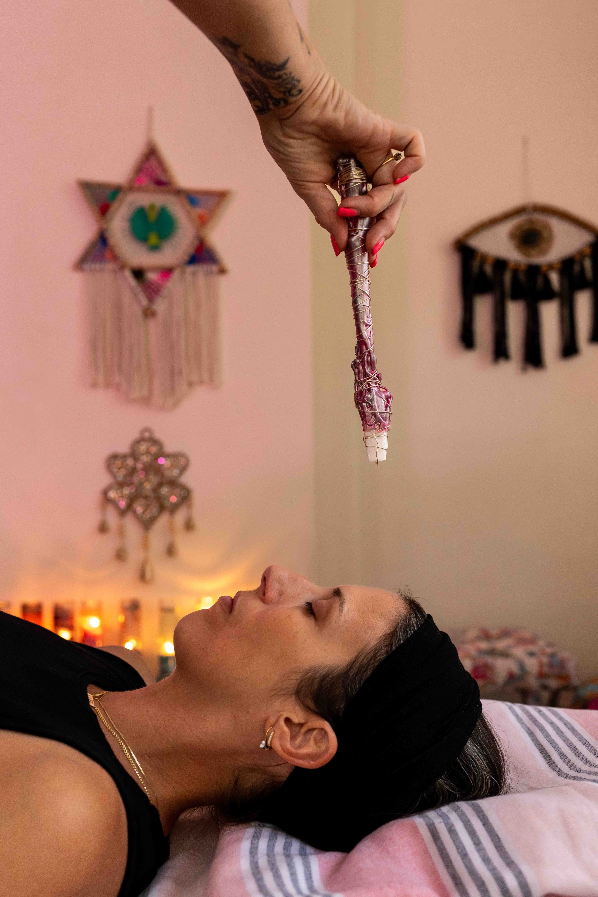 documentary branding photography crystal wand passing over a woman during reiki session