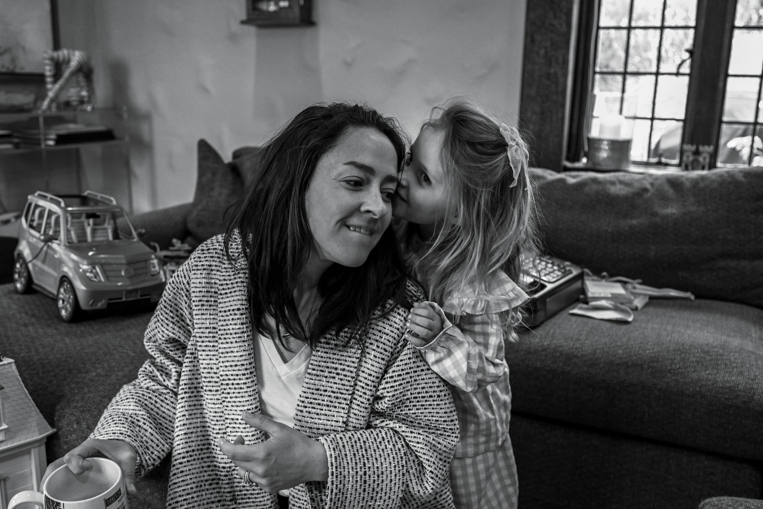 documentary family photography child whispering to her mother