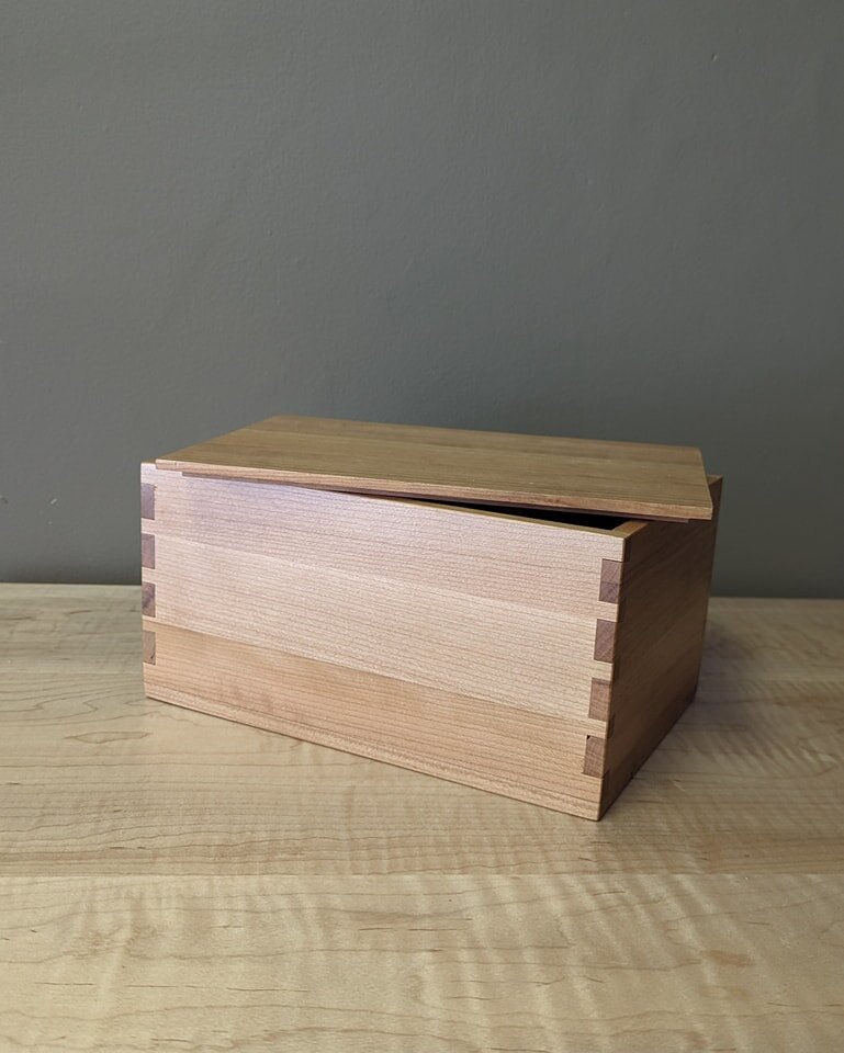 We've created some beautiful new dovetail boxes that are being showcased at our store front. 
The first box pictured with a lid could be used as a jewelry box, storage for pictures or other odds and ends, or bathroom storage.