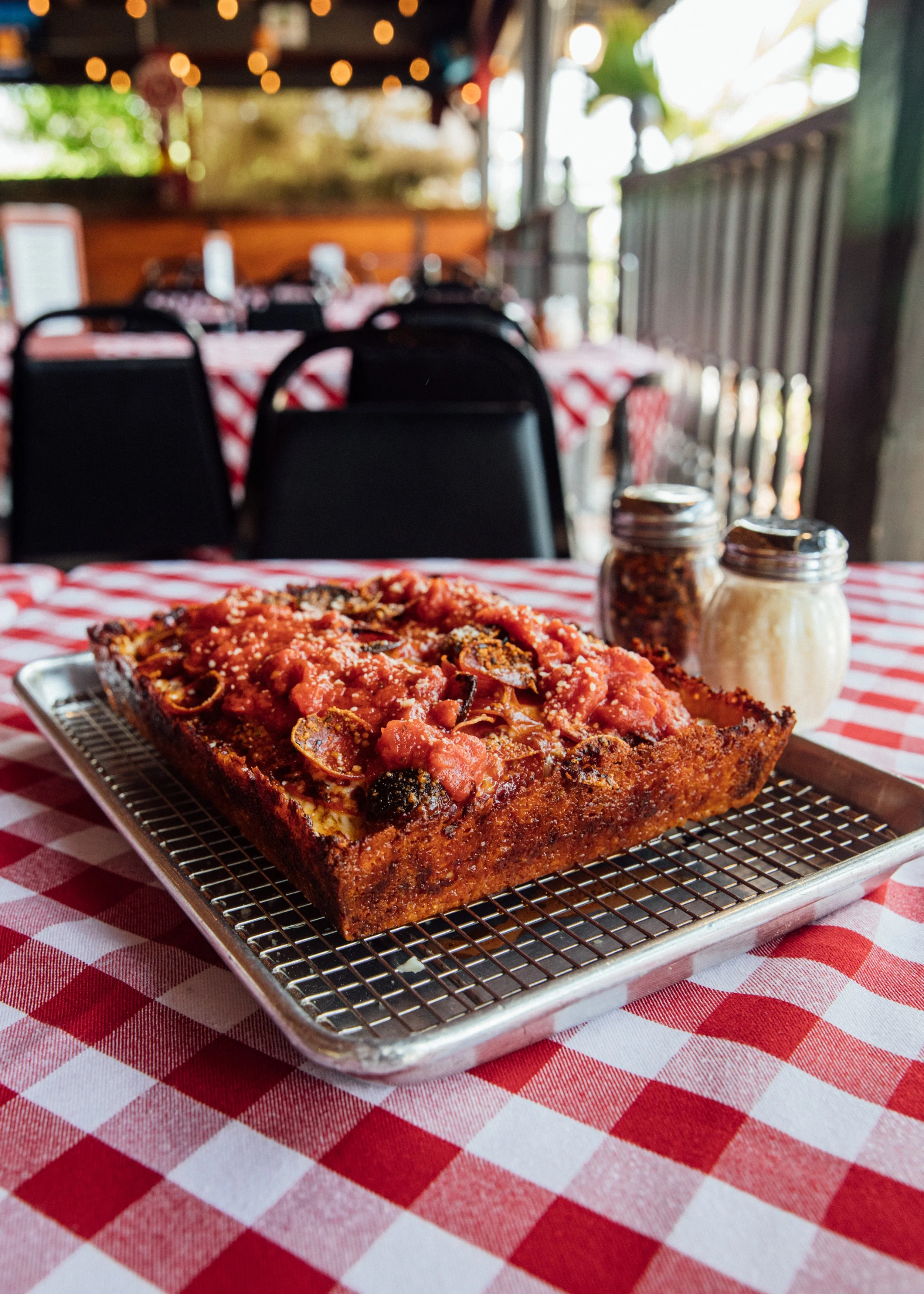 Detroit-style pepperoni pizza on a red checkered table