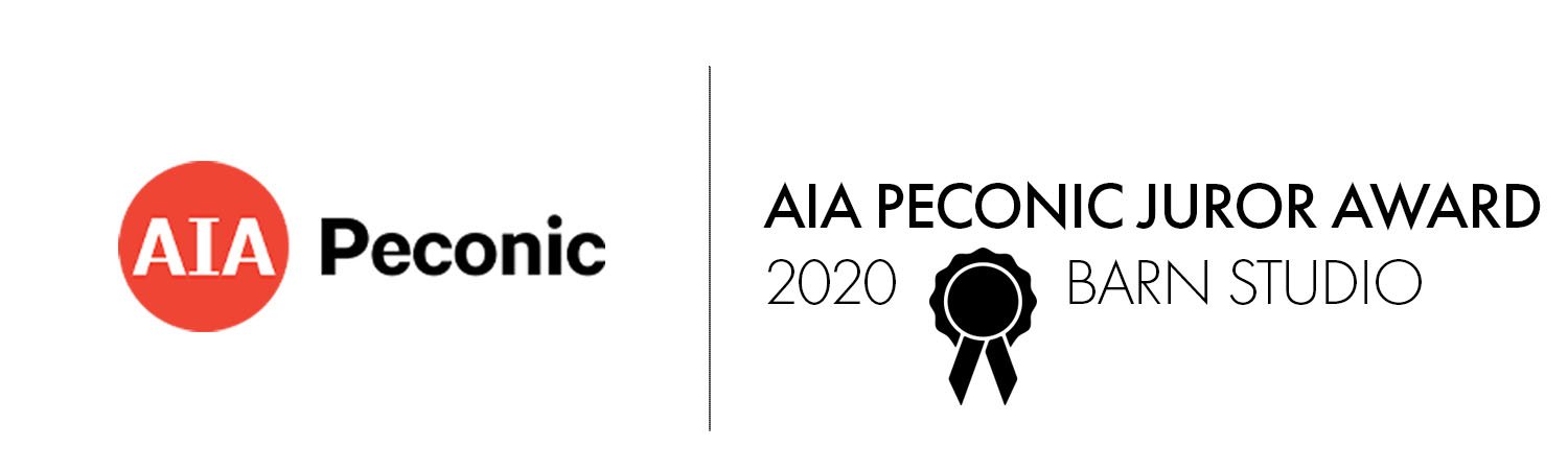 A graphic with the AIA Peconic logo on the left and the words "AIA Peconic Juror Award 2020 Barn Studio" along with a black ribbon in the center on the right.