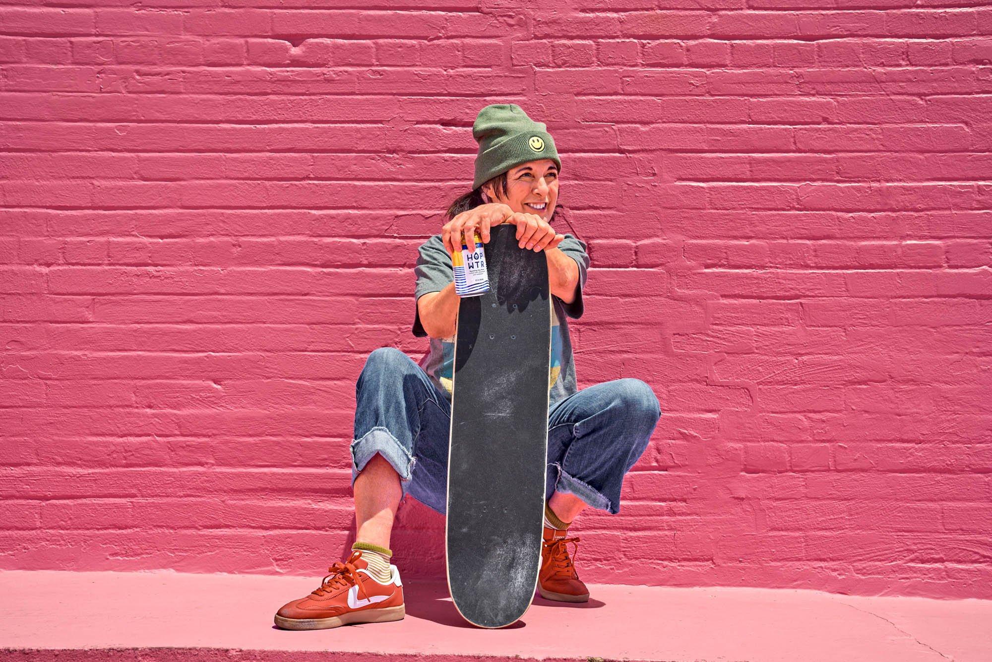 Joyful sunny aesthetic lifestyle branding photography captured on location with female talent and beverage brand