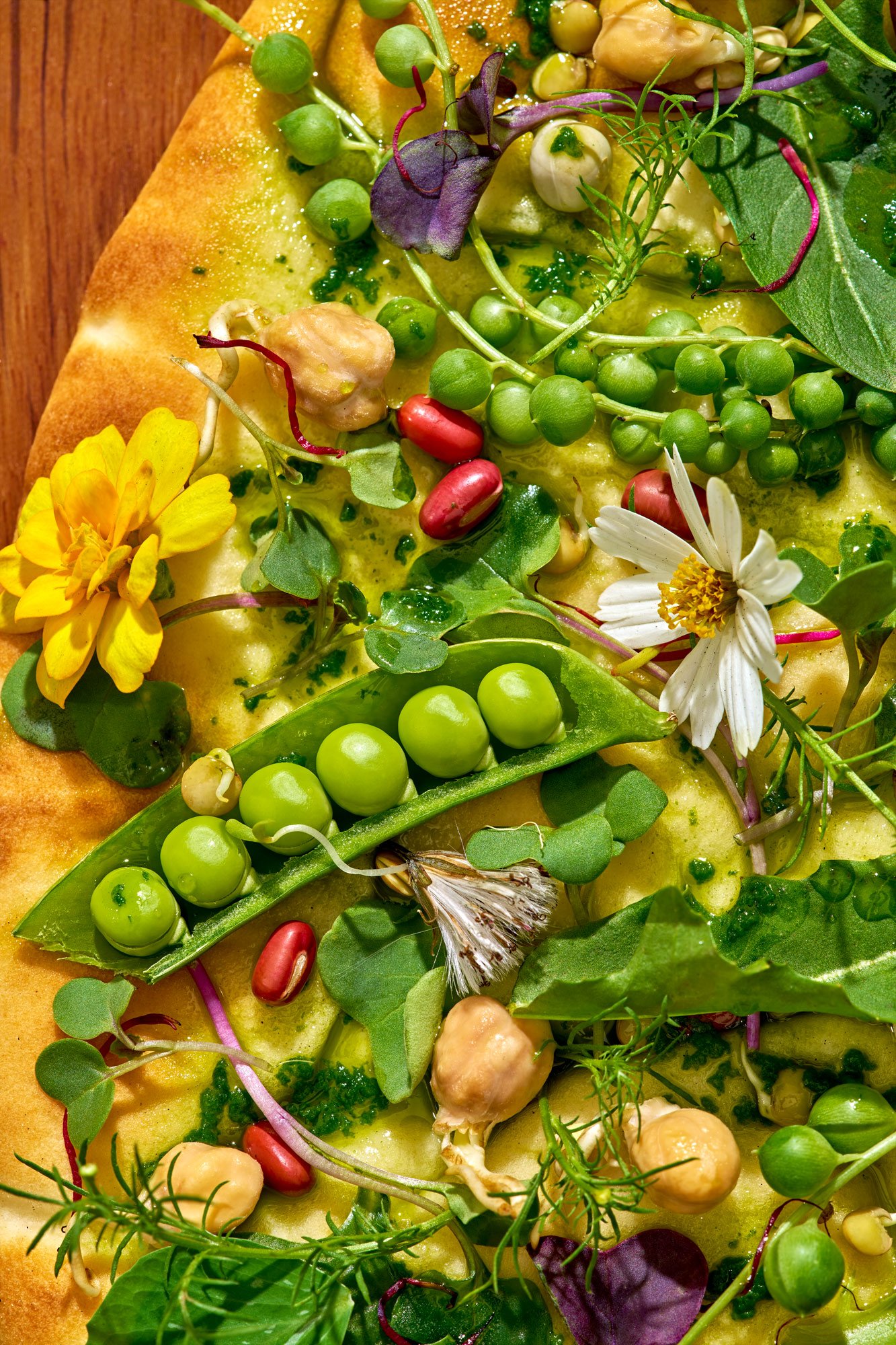 Commercial editorial style detail food photo featuring a wild-foraged flatbread. Photo by Suzanne Clements, commercial and editorial photographer based in Orlando and Chicago, available nationally.