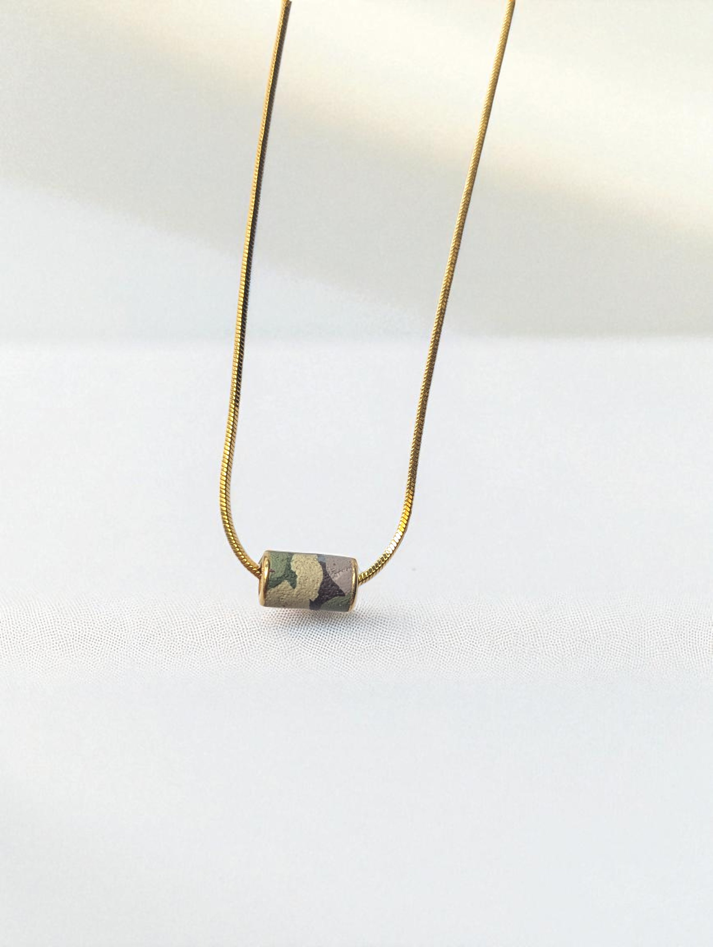 Camouflage_Peprin_Cylinder_Necklace_White_Background-Photoroom.jpg