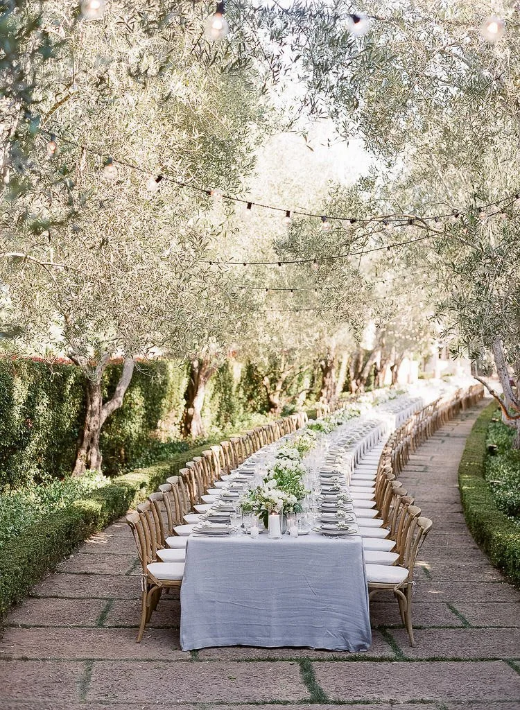 Long dining table at a Santa Barbara garden party wedding reception designed by LA wedding designer and planner Eddie Zaratsian 