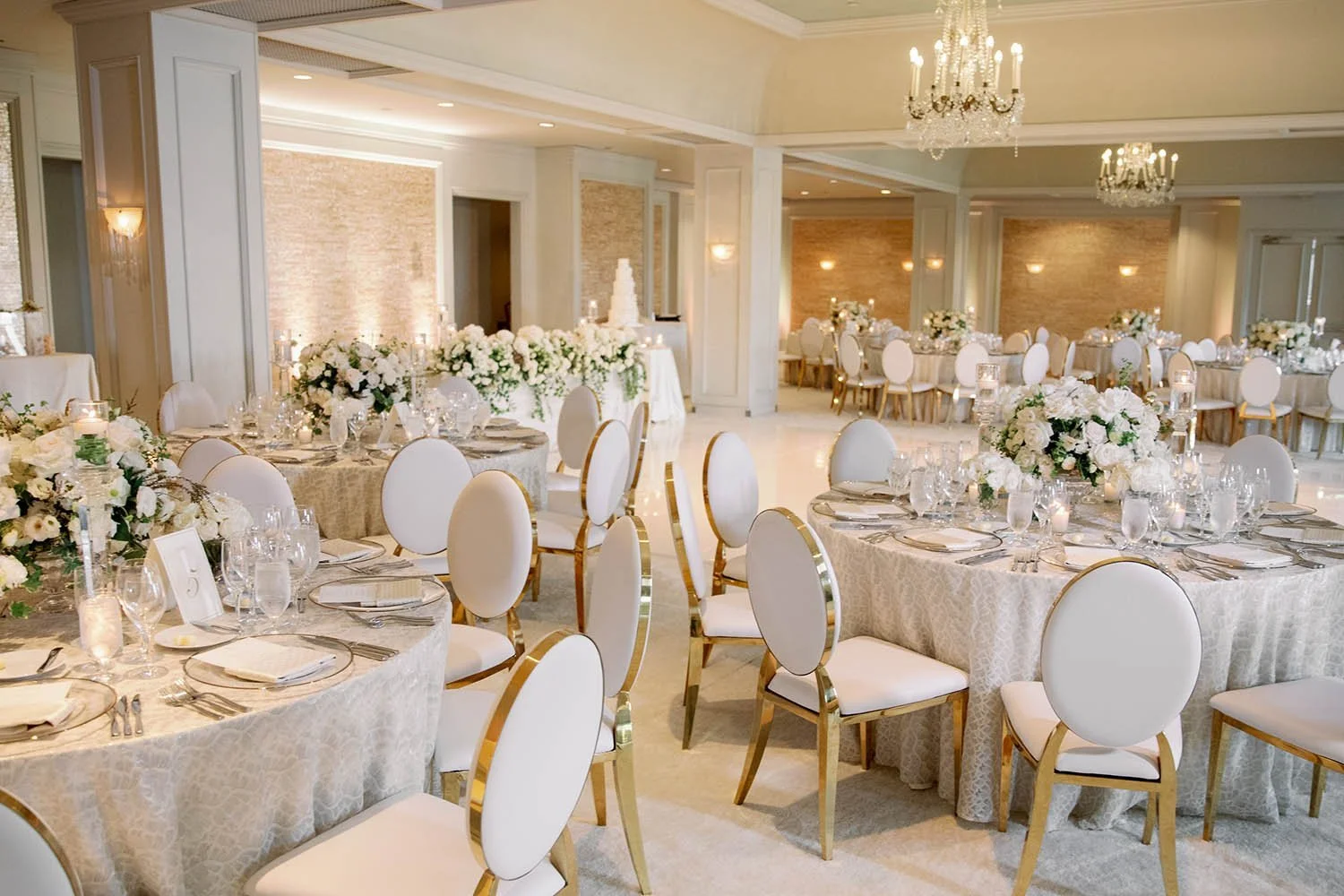 Romantic White Wedding Florals with Soft Candlelight and Layered Reception Styling