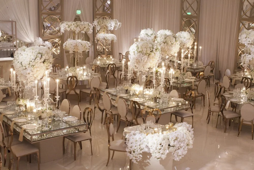 Wedding Floral Design with Elevated White Blooms and Soft Candlelight in an Elegant Reception