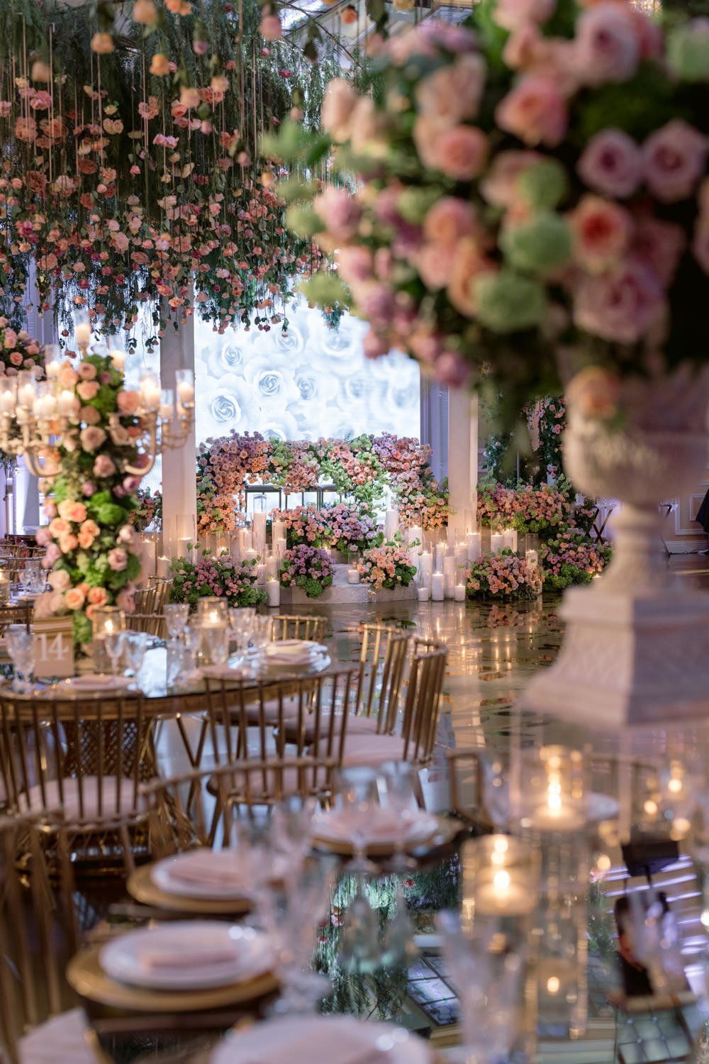 Cascading deep pink and cream roses surround gold and cream table settings to create an enchanted garden at the Taglyan Cultural Complex - Eddie Zaratsian Lifestyle &amp; Design