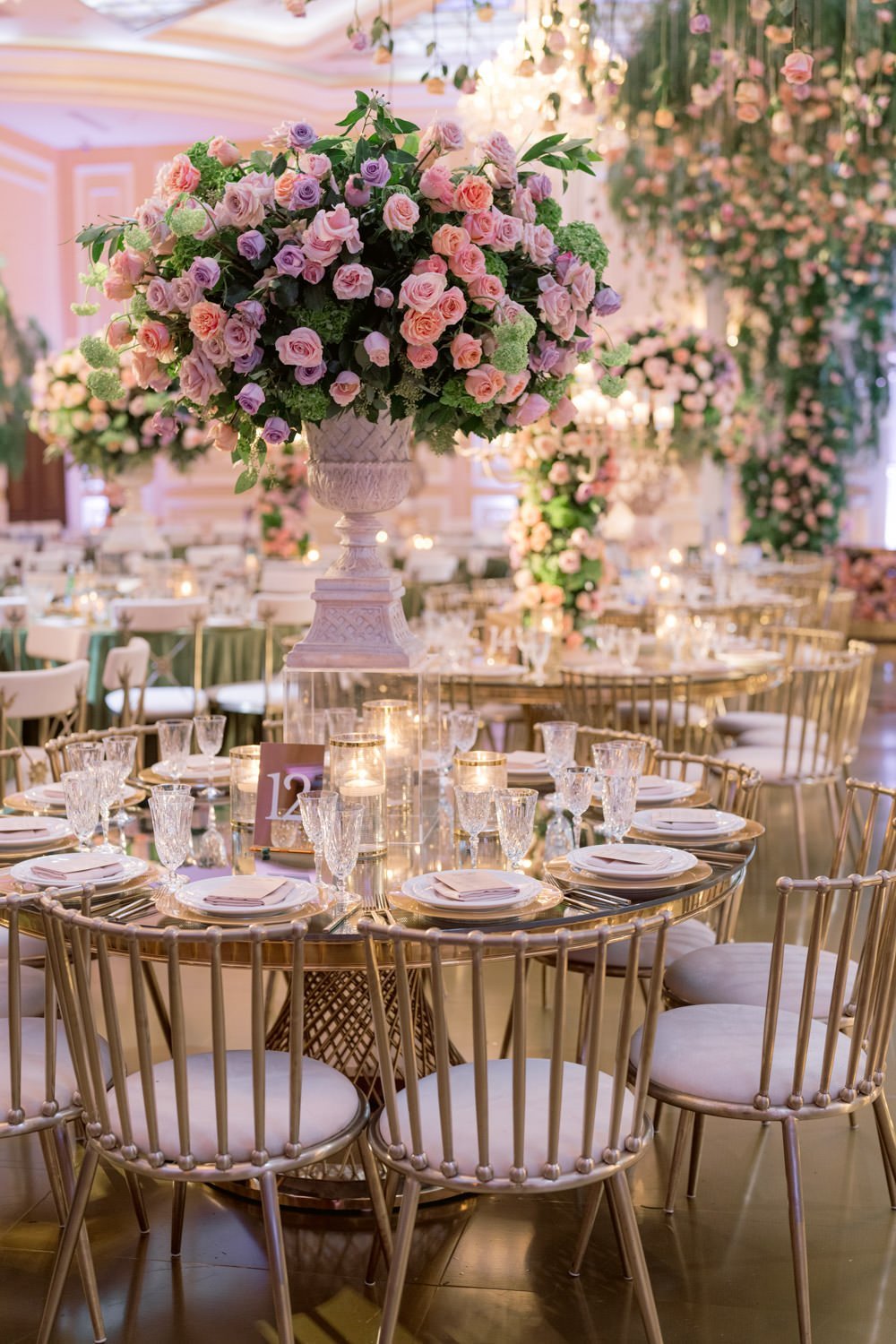 Cascading deep pink and cream roses surround gold and cream table settings to create an enchanted garden at the Taglyan Cultural Complex - Eddie Zaratsian Lifestyle &amp; Design