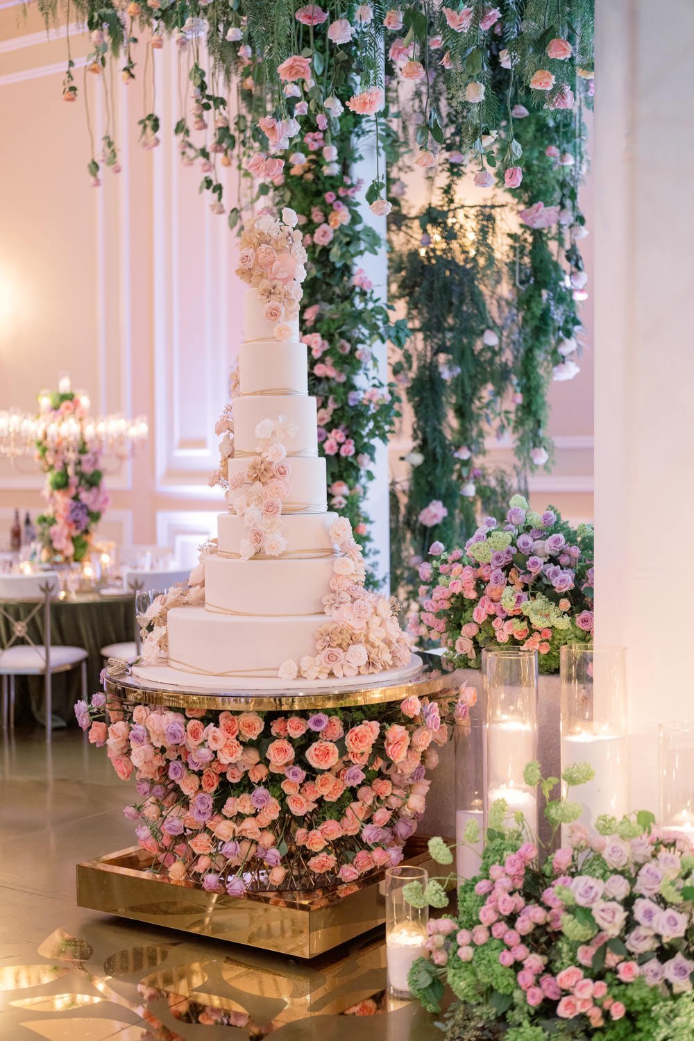 Pale pink and cream roses twist around a seven layer cream wedding cake with gold and cream accents at the Taglyan Cultural Complex - Eddie Zaratsian Lifestyle &amp; Design