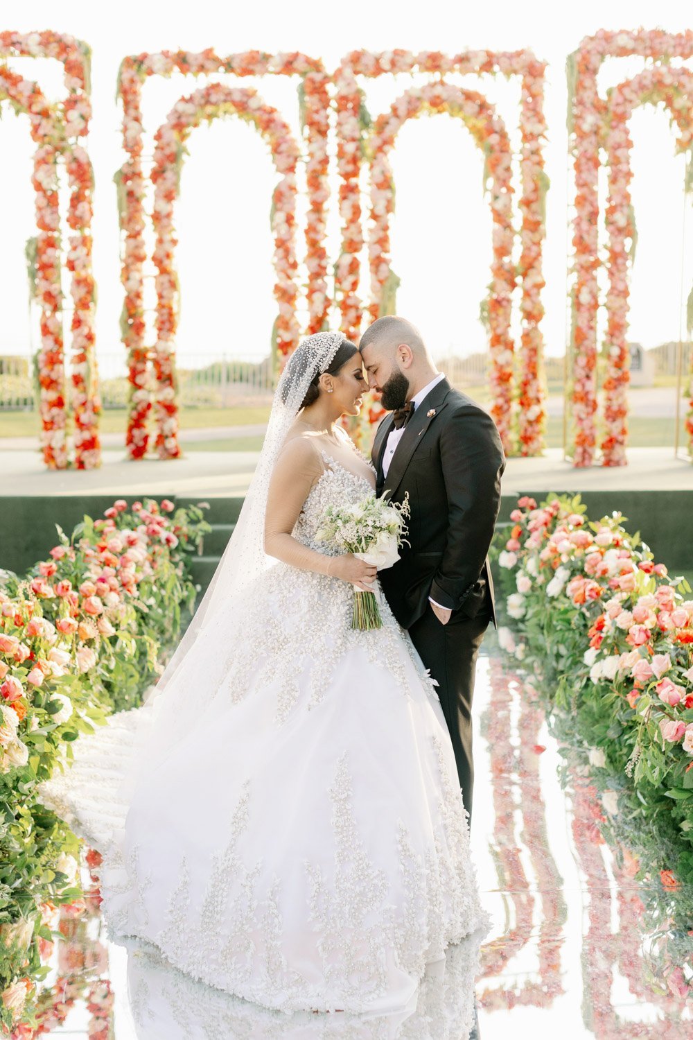 Spectacular peach, coral and roses showcase the outdoor ceremony at the Ritz-Carlton Laguna Niguel