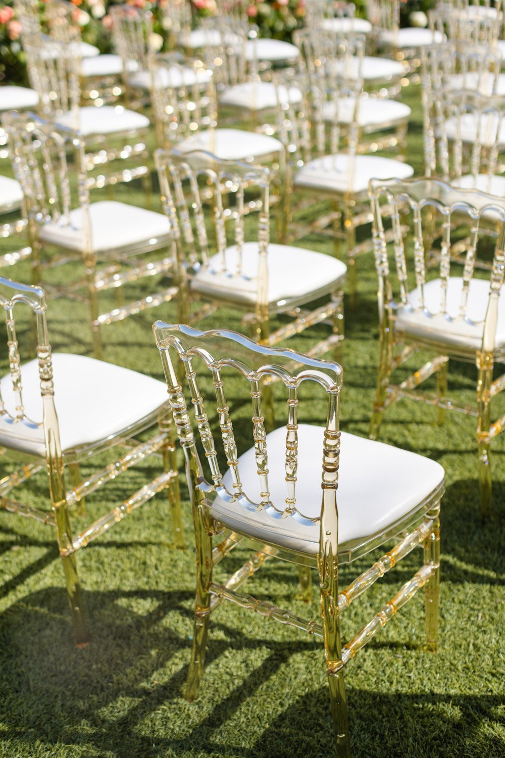 Clear crystal like chairs with gold and cream accents make up the ceremony seating at the Ritz-Carlton Laguna Niguel