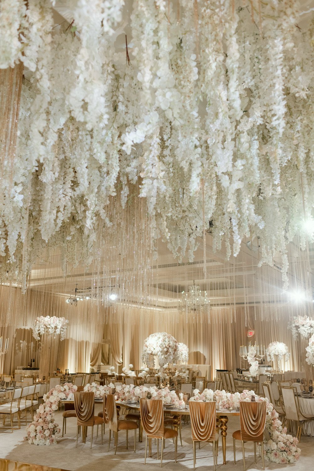 Pale pink and cream roses surrounded by crystals and gold accents create a bright and bold ballroom setting at the Ritz-Carlton Laguna Niguel