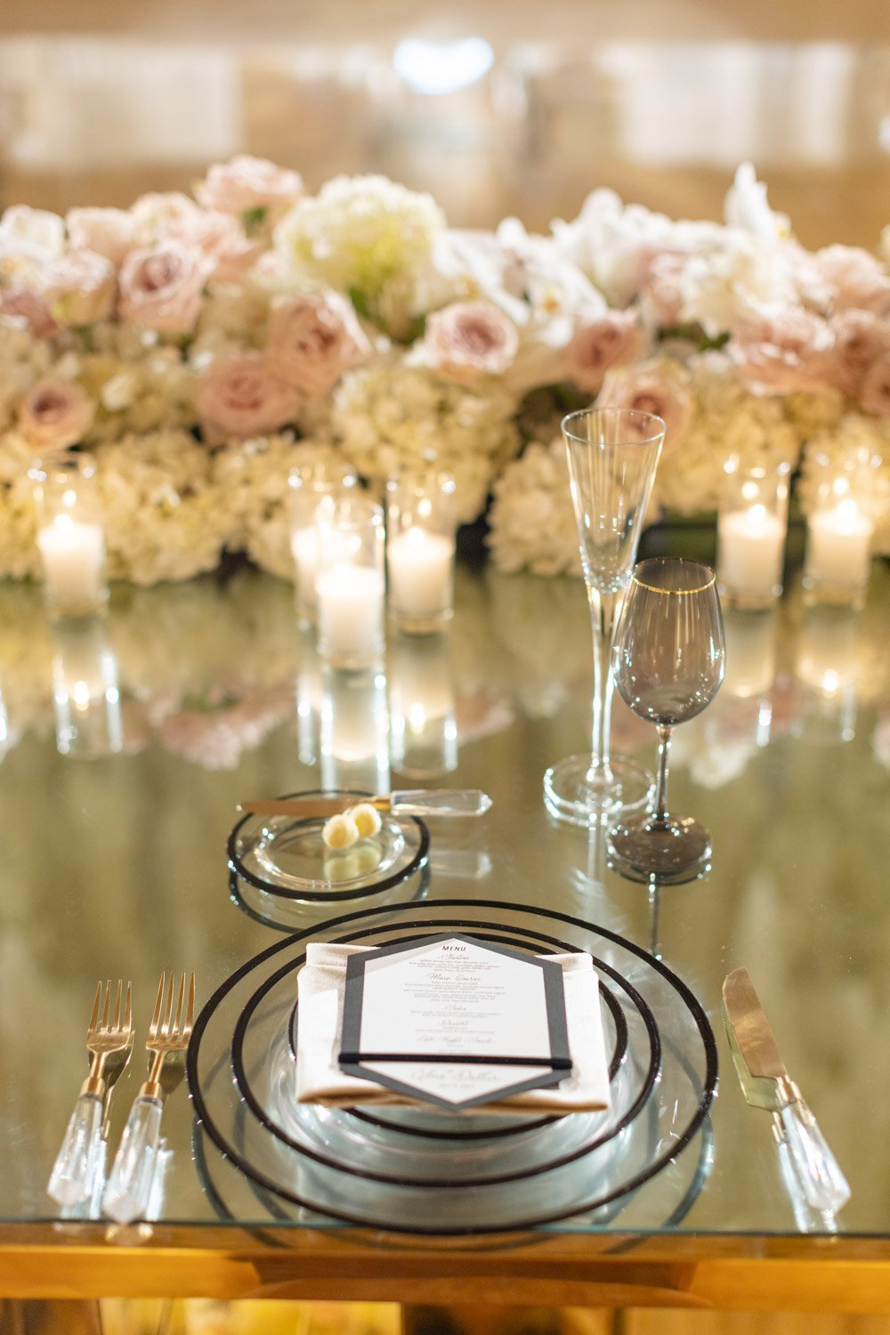 Cream peonies accent gold and black place settings at the Ritz-Carlton Laguna Niguel
