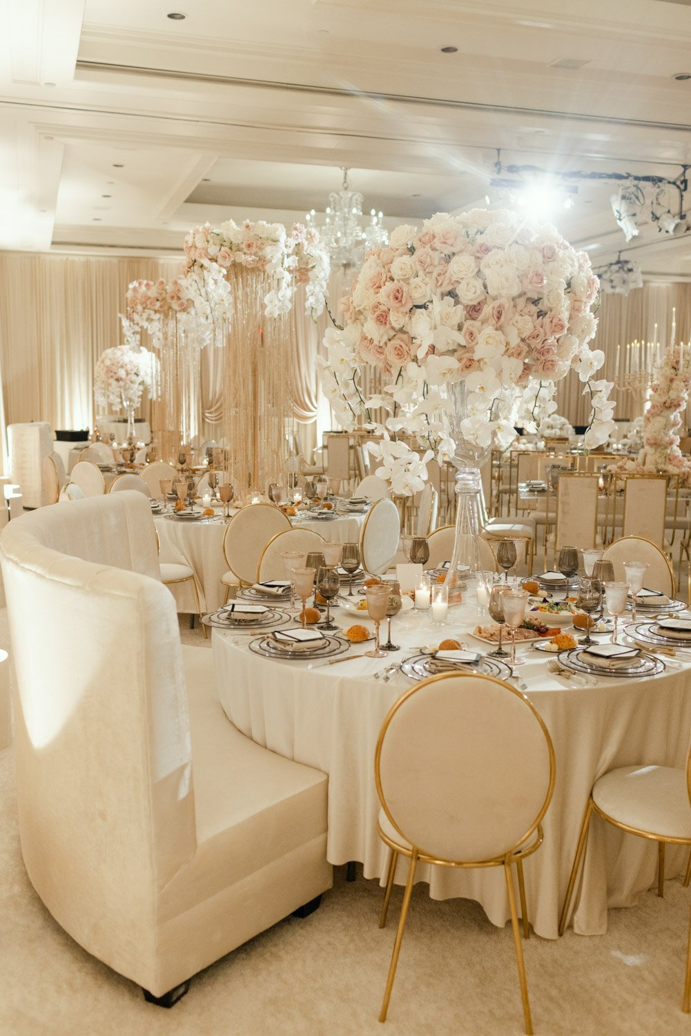 Pale pink and cream rose tall table centerpieces highlight crystal and gold accents at the Ritz-Carlton Laguna Niguel