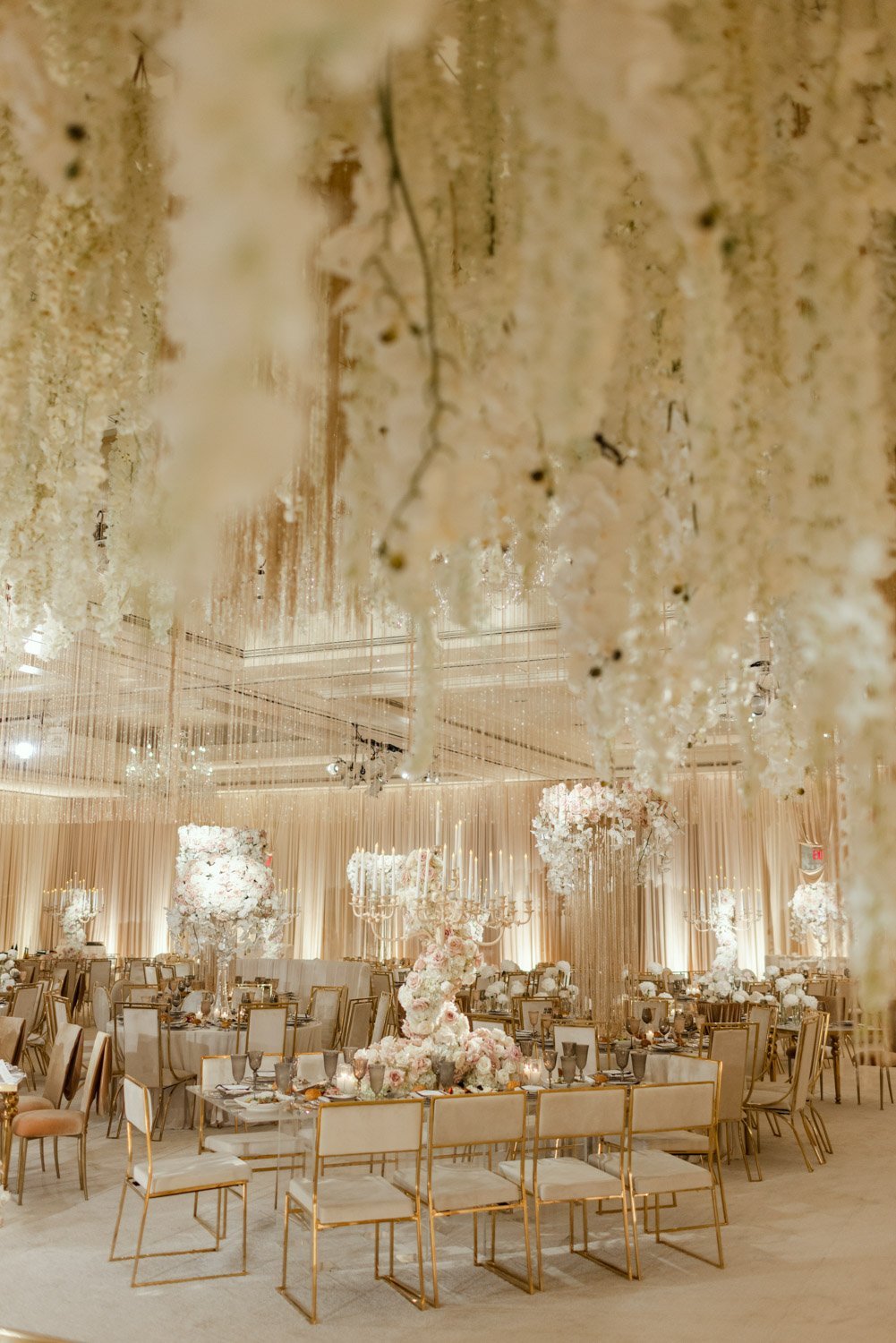 Pale pink and cream roses surrounded by crystals and gold accents create a bright and bold ballroom setting at the Ritz-Carlton Laguna Niguel
