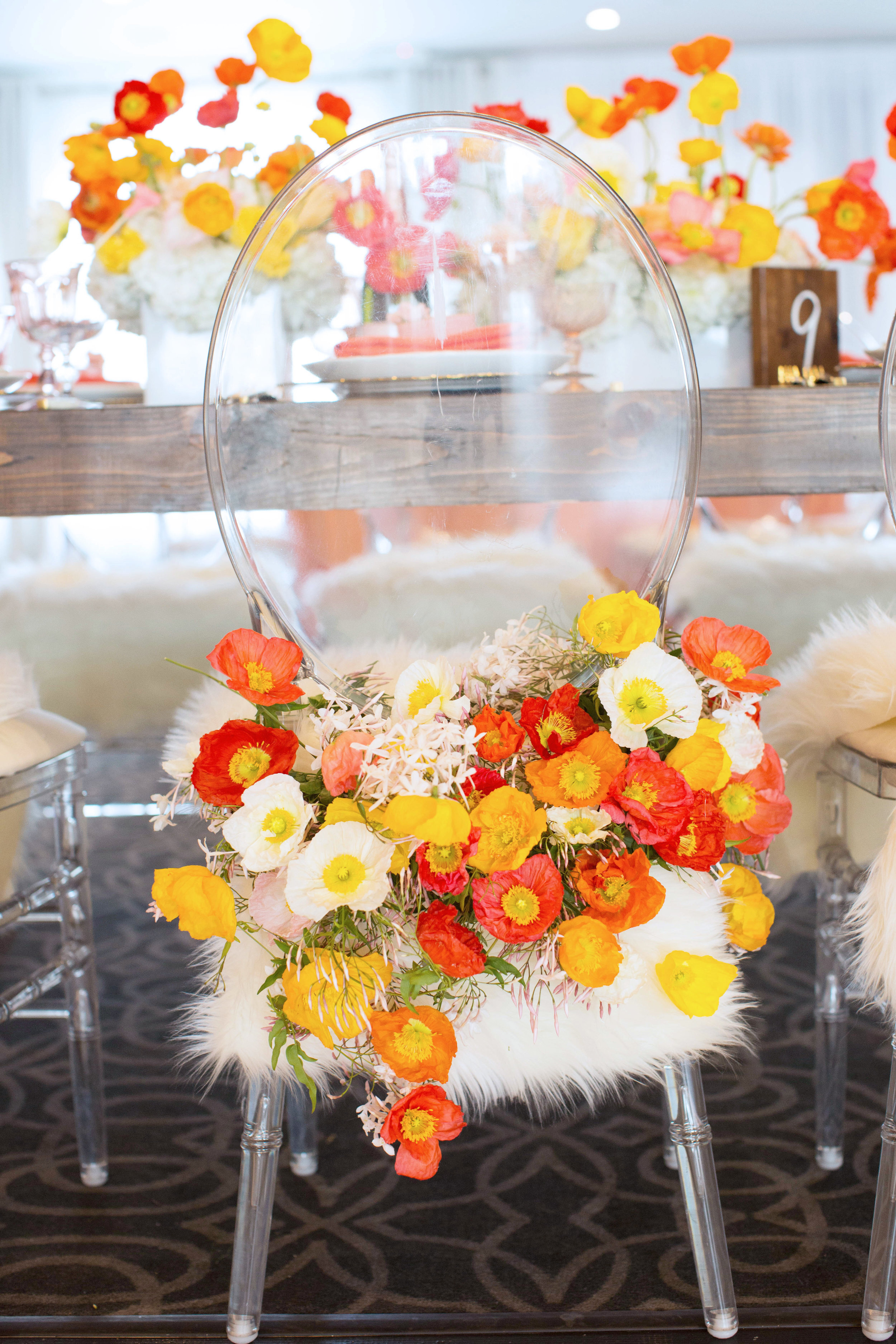 Colorful Poppy chair decoration on a lucite ghost chair at a Spring Bridal Shower designed by Eddie Zaratsian Lifestyle & Design