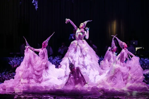 Performers in lavender wedding colors gowns at a purple themed reception