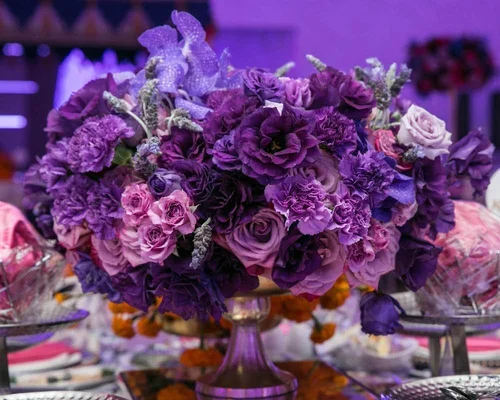 Purple wedding flowers centerpiece with lavender orchids and roses