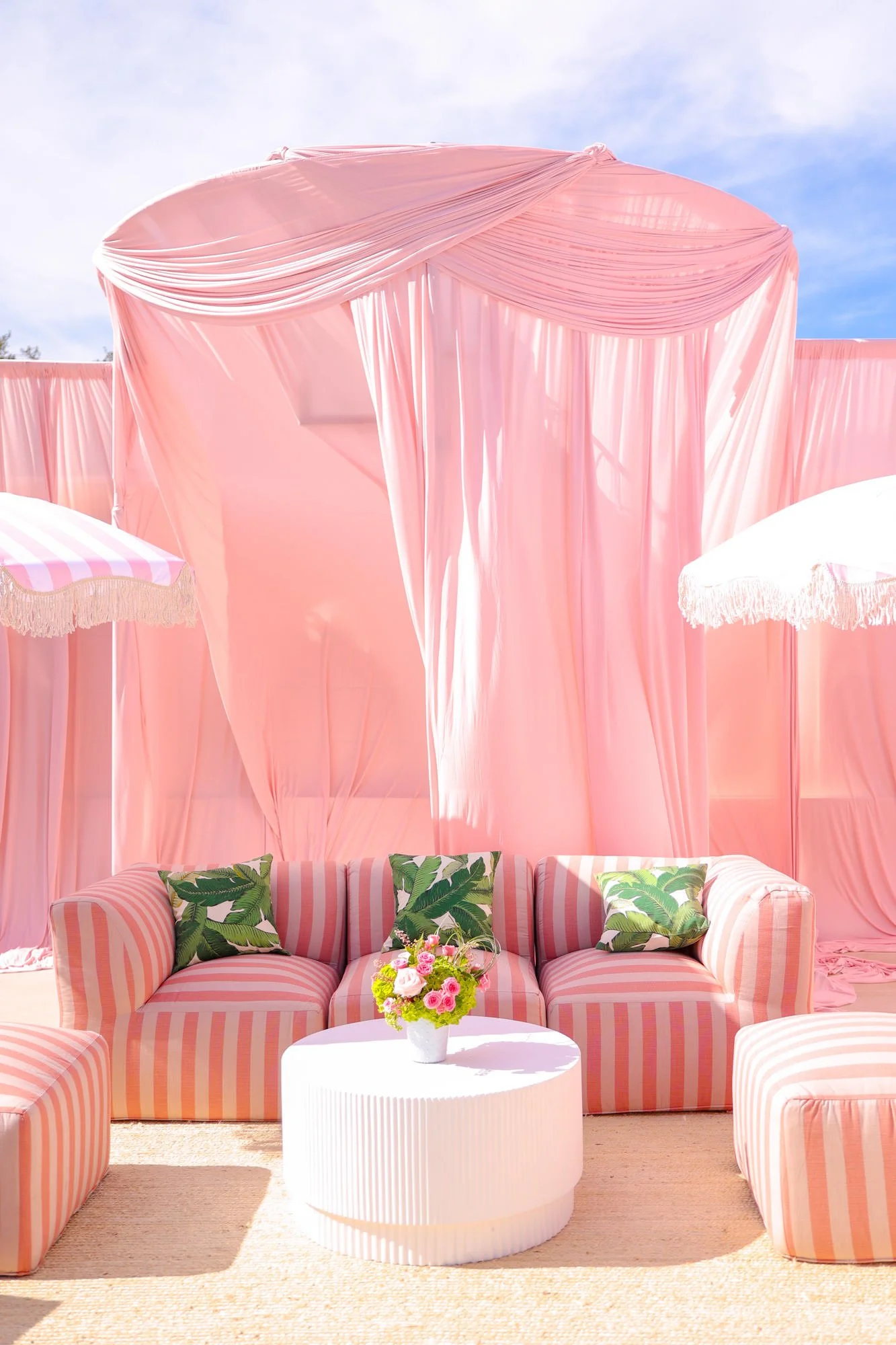 Pink striped cabana at a 1st birthday pool party designed by LA event designer and planner Eddie Zaratsian 