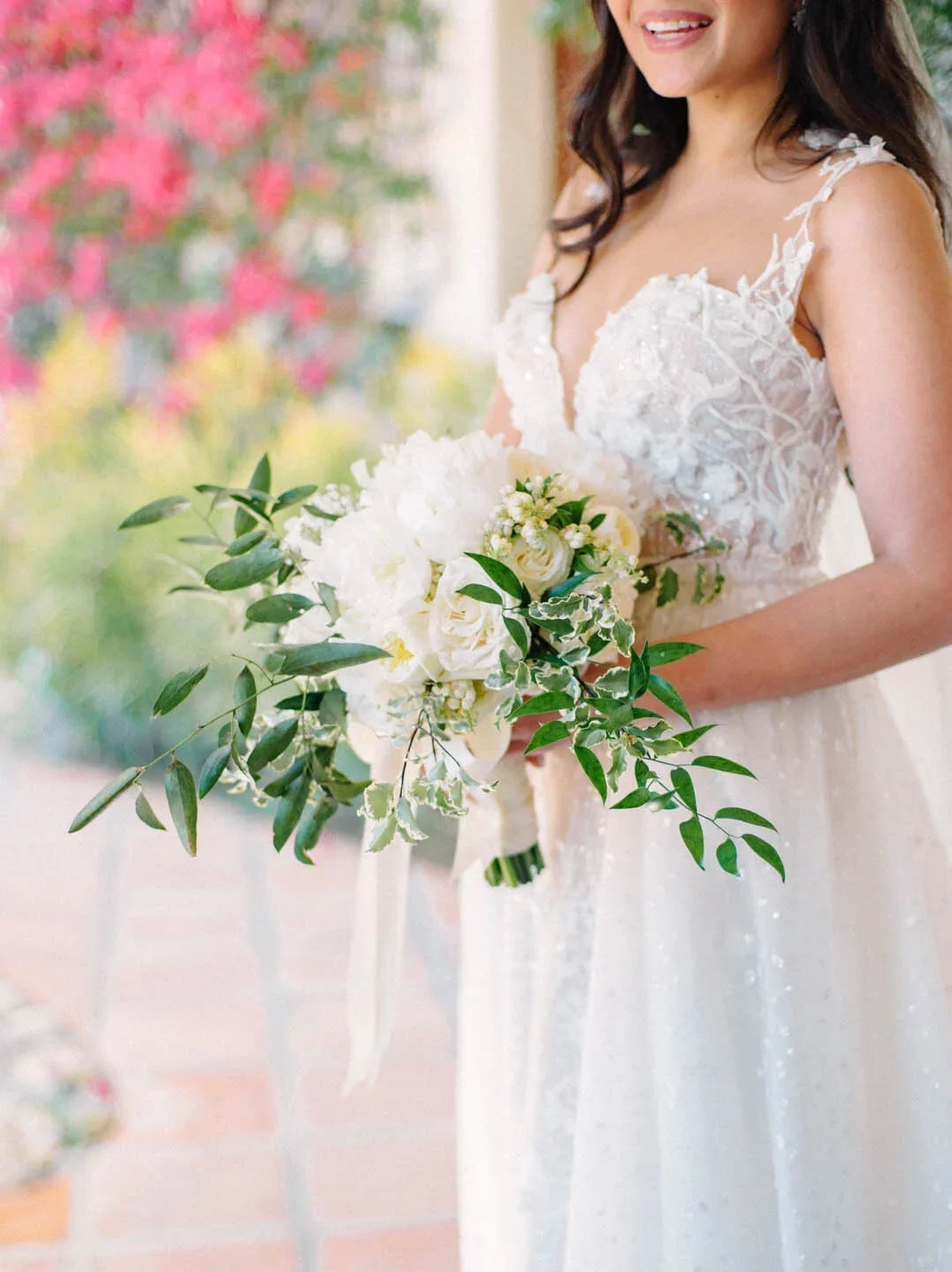 Romantic white bridal bouquet designed by Eddie Zaratsian featuring soft movement and layered white blooms inspired by Pantone Color of the Year 2026 Cloud Dancer.