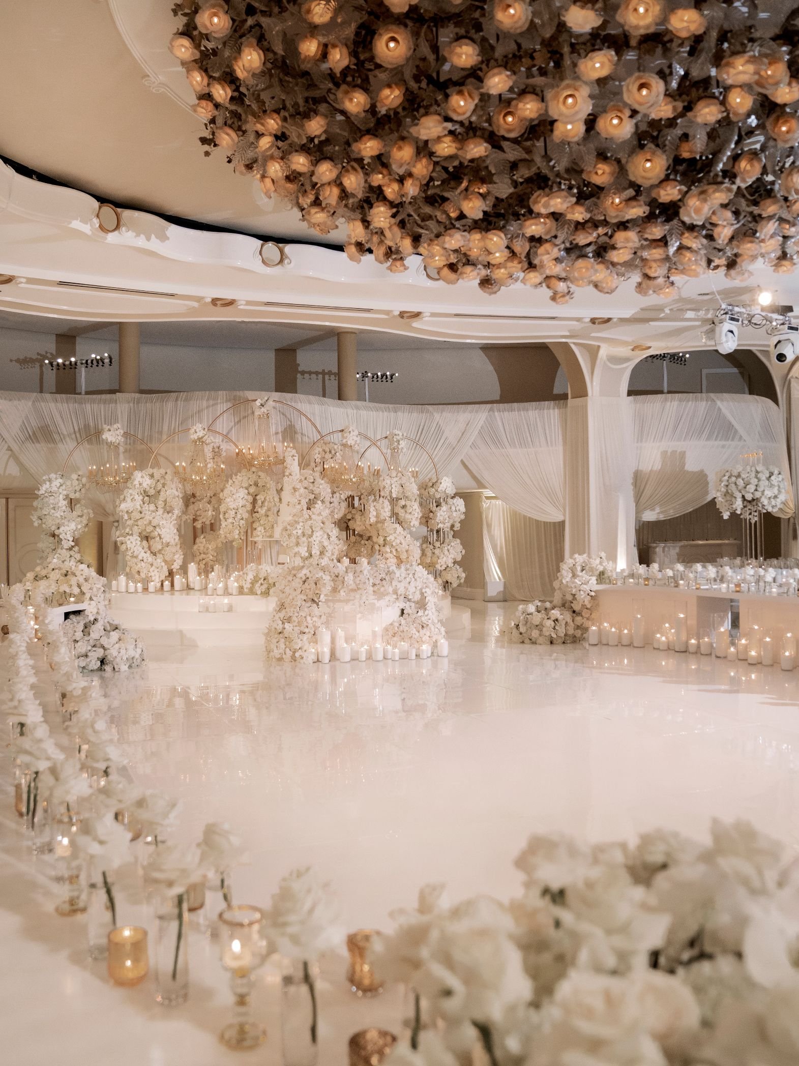 Wedding Cake Display Surrounded by Lush White Florals at a Beverly Hills Hotel Wedding