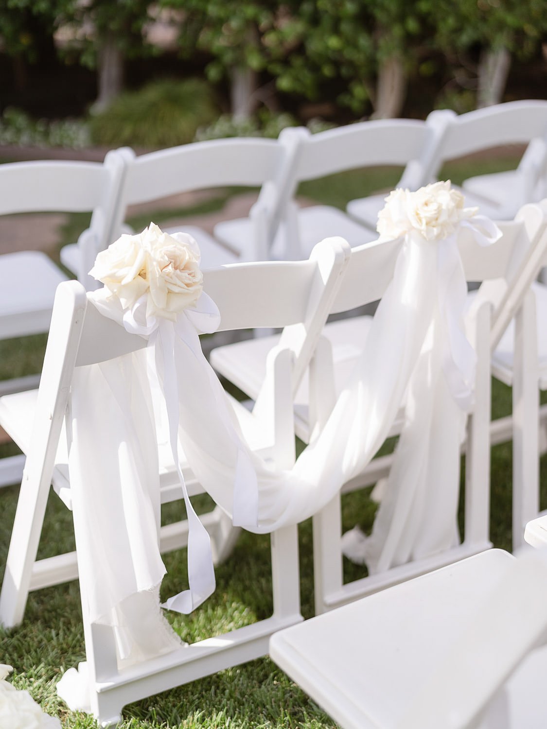 White and green summer wedding ceremony chairs outside at the Beverly Hills Hotel, flowers by Eddie Zaratsian Lifestyle and Design