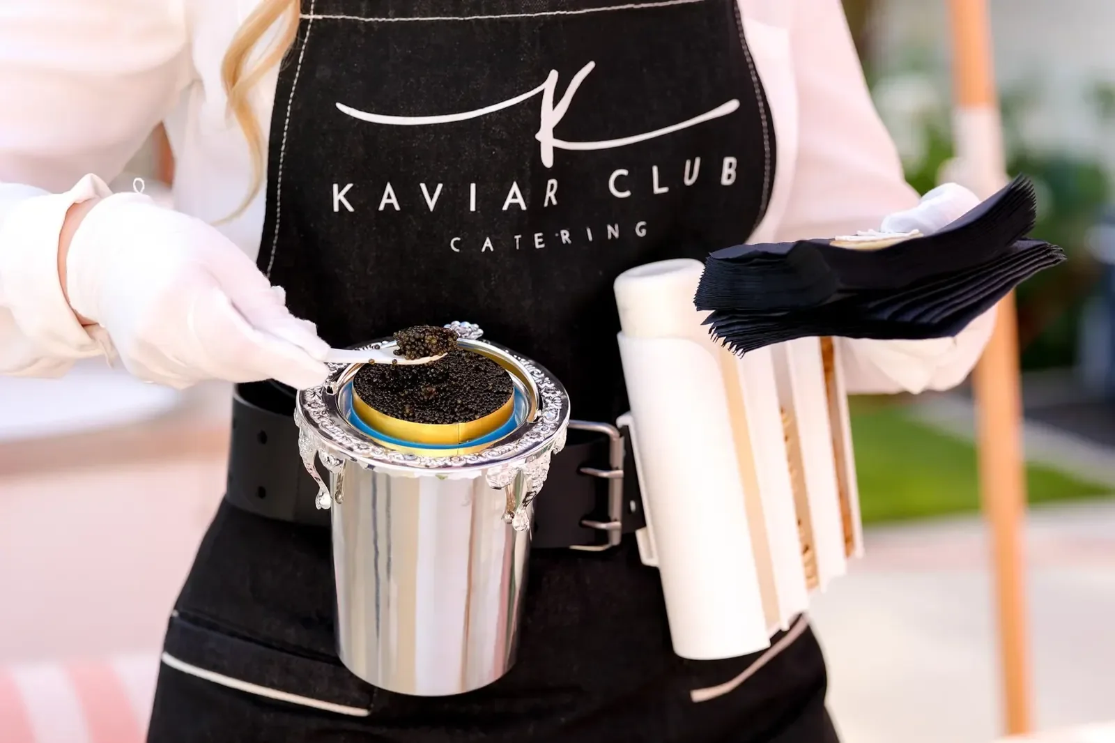 Kaviar Club catering service pouring caviar at a luxury party planned by a party planner and event producer
