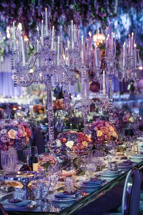 Purple wedding theme reception with wisteria ceiling and hanging chandeliers