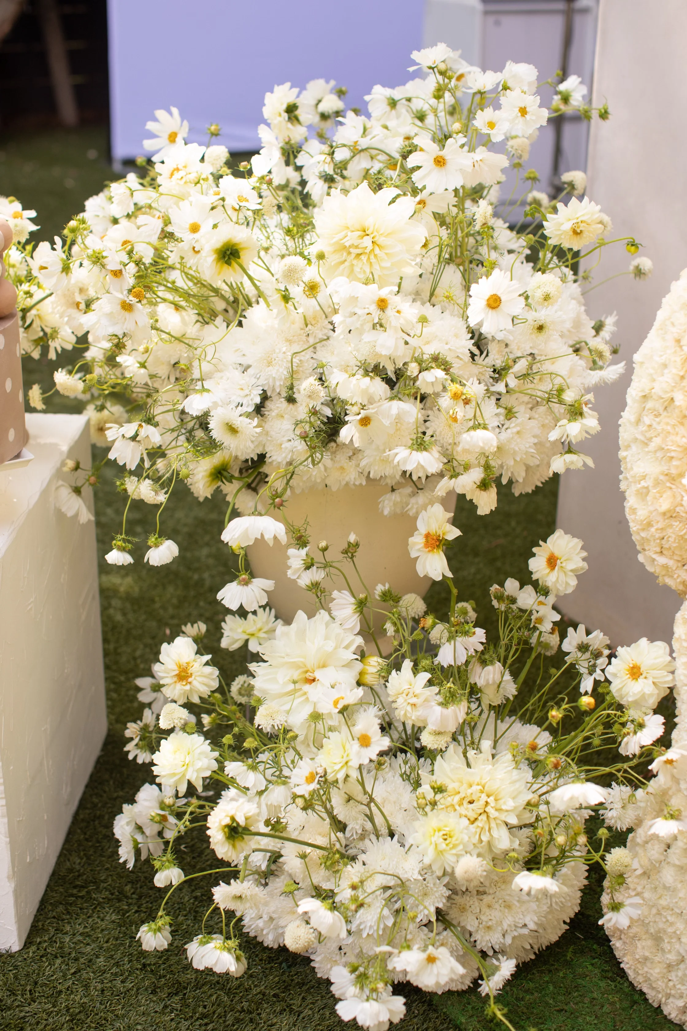 Teddy bear holding fresh flowers as part of a teddy bear baby shower decoration display
