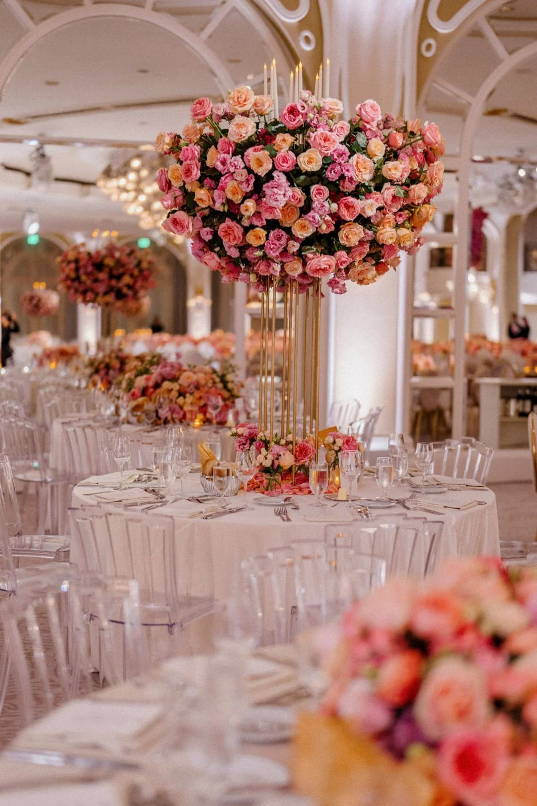 Luxury wedding floral centerpiece at Beverly Hills Hotel with pink and coral roses on tall gold candlestick base