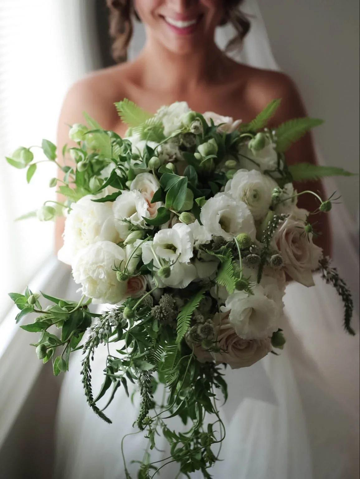 Textural romantic white bridal bouquet by Eddie Zaratsian highlighting bloom variation and softness within a Pantone Color of the Year 2026 Cloud Dancer palette.