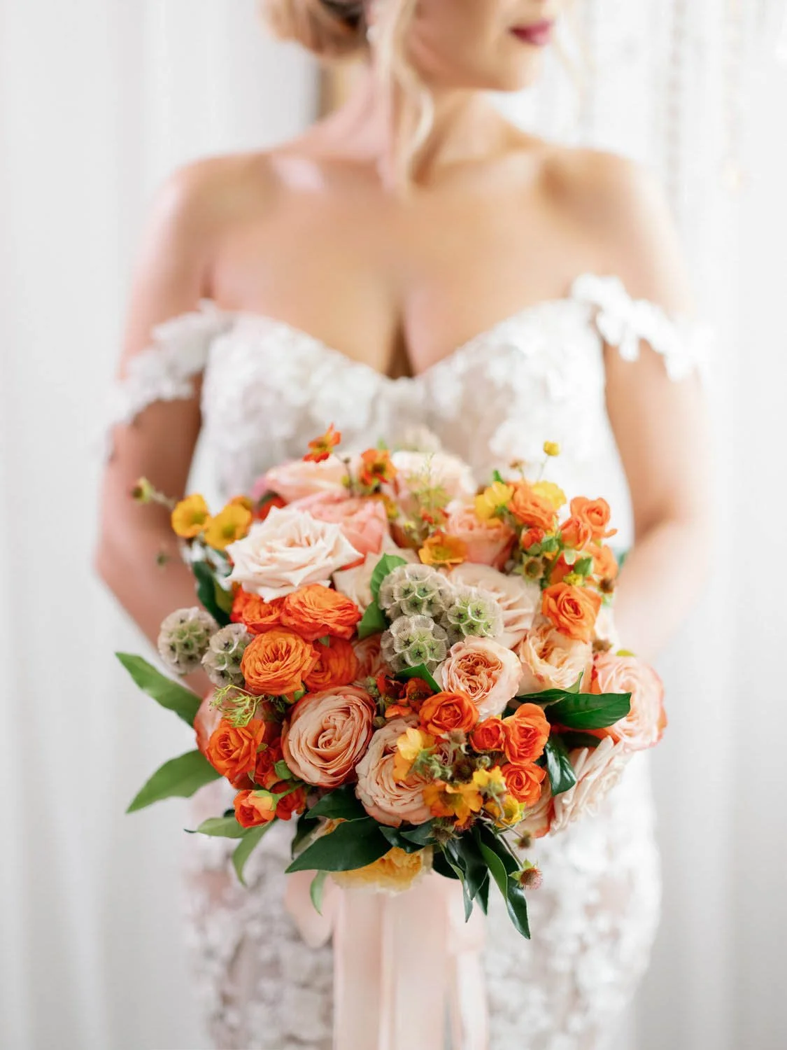 Colorful wedding bouquet held by a stylish bride, designed by LA wedding designer and planner Eddie Zaratsian 