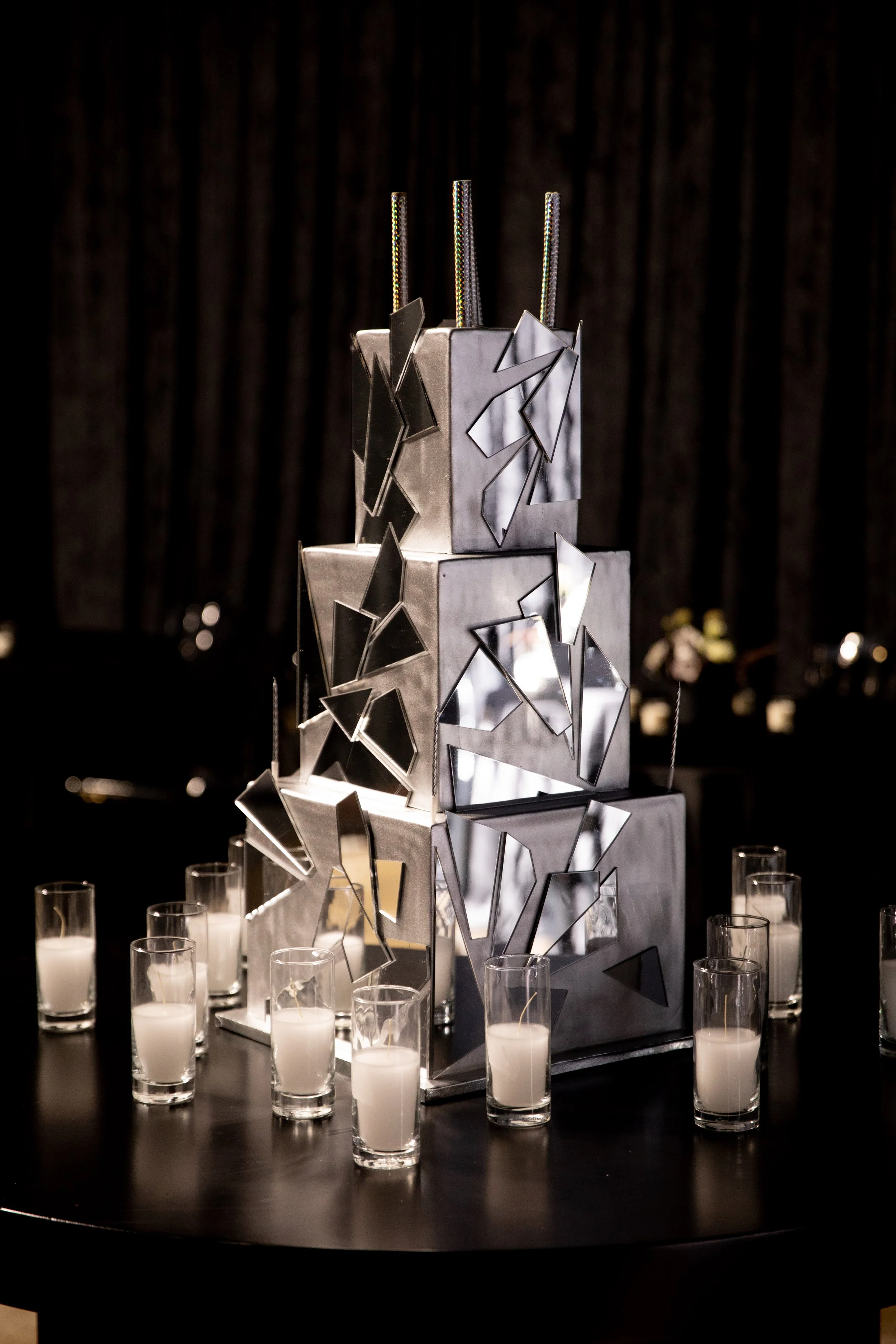 Geometric Birthday Cake Display with Candlelight and Metallic Styling for a Luxury Event in Los Angeles