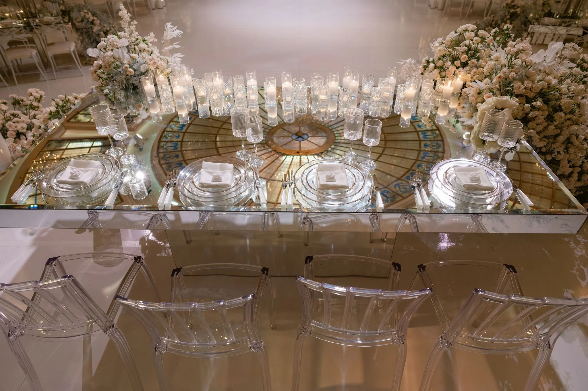 Wedding Planner Creating an Elegant Ceremony Setup with Lush White Florals and Aisle Design