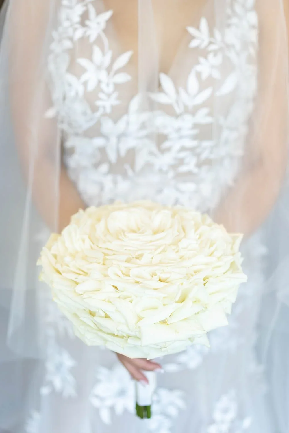 Structured white bridal bouquet with ribbon detail designed by Eddie Zaratsian, showcasing refined floral composition inspired by Pantone Color of the Year 2026 Cloud Dancer.