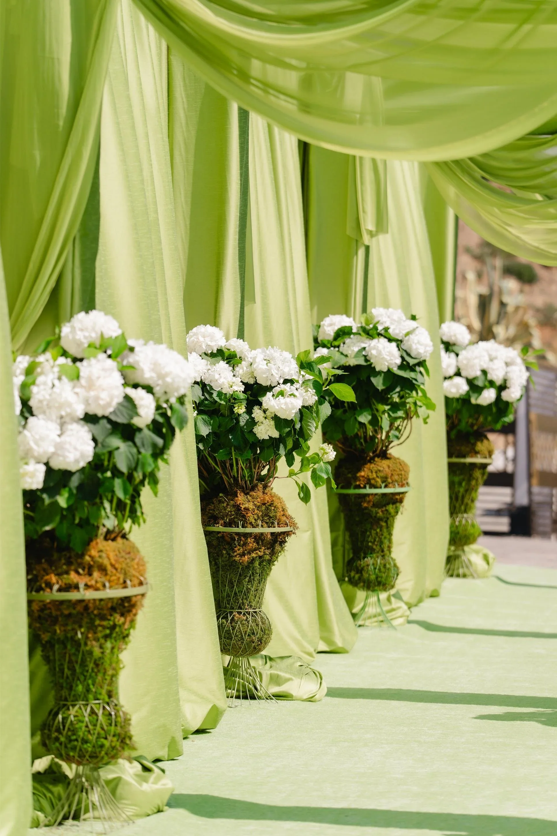 Luxury Corporate Event Design in Los Angeles with Green Floral Installations and Structured Styling