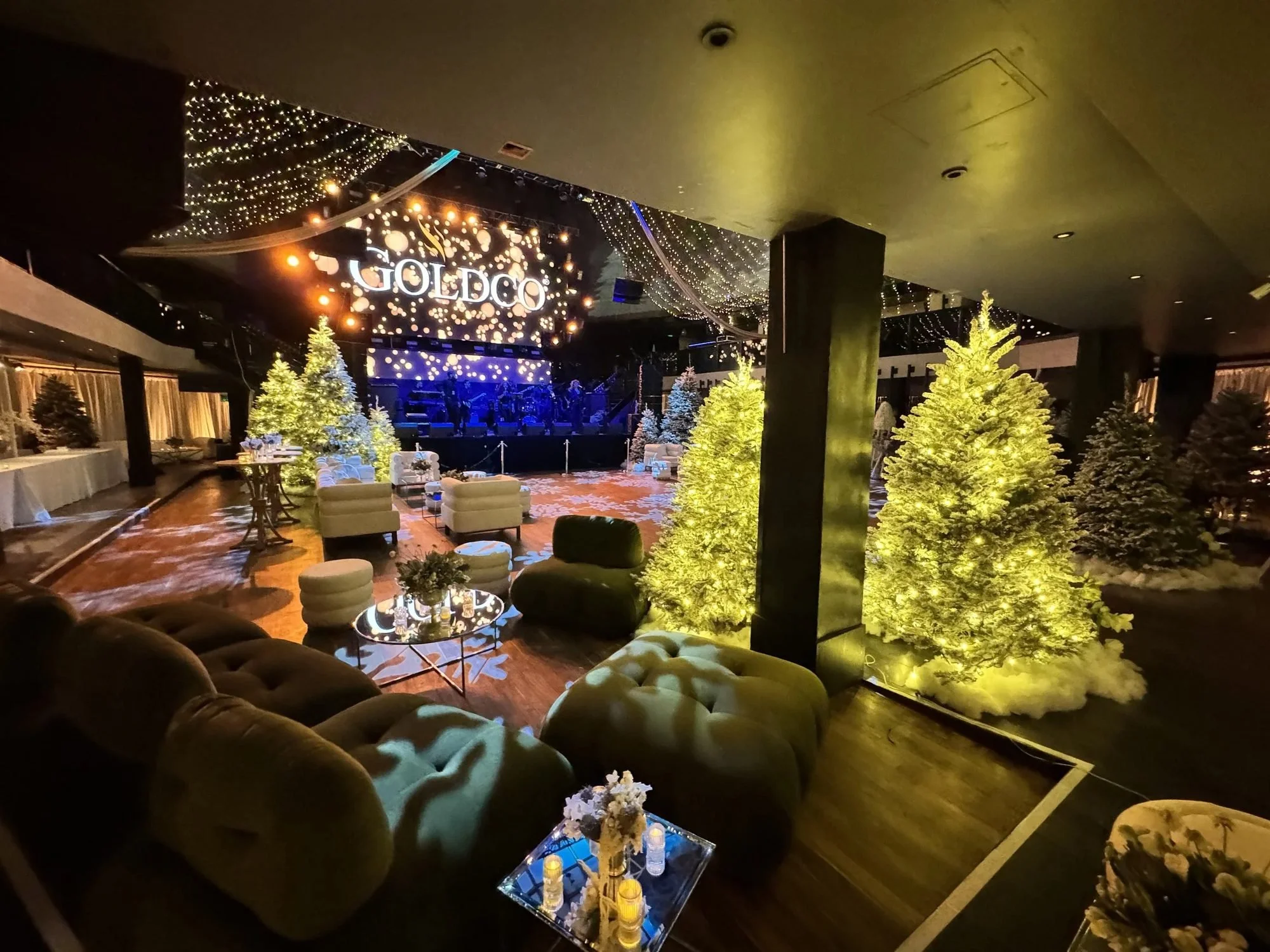 Corporate holiday decorating for the Gold + Co holiday party with lit Christmas trees and lounge seating, by Eddie Zaratsian in Los Angeles