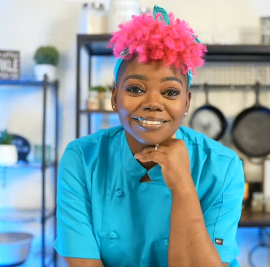 A woman with shoulder-length blonde hair smiles at the camera, wearing a light blue collared shirt with a logo that says 'Lee & Cates Glass'.