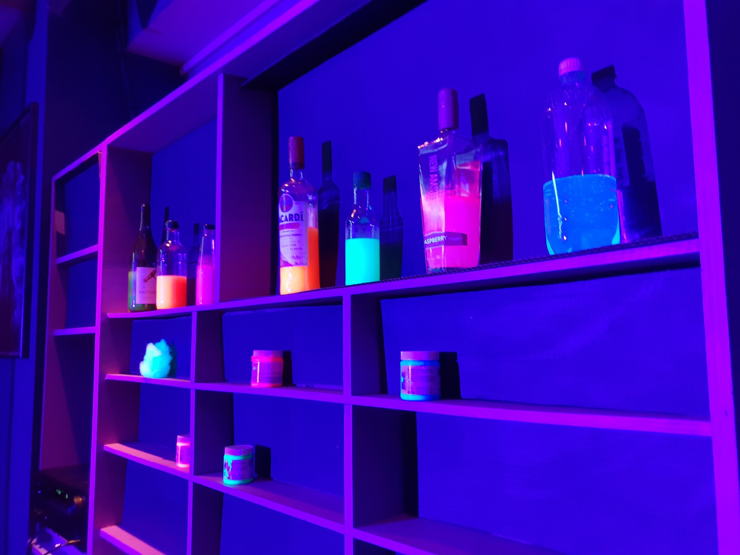 filled alcohol bottles with tonic water and neon paint water that would glow under the black light.