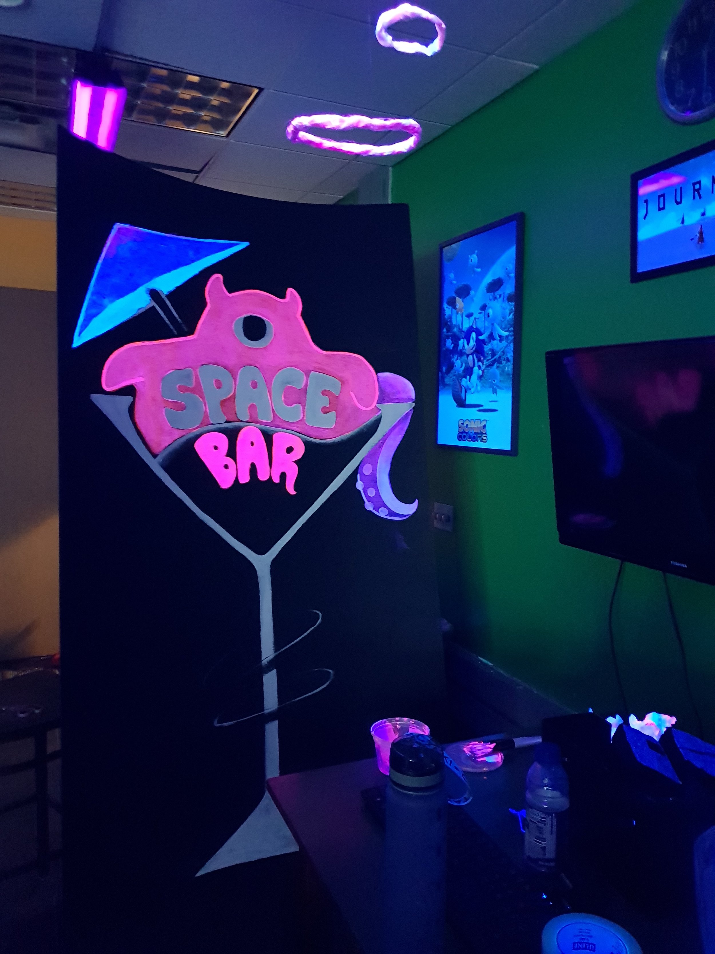 painting the main entrance sign with neon paint.