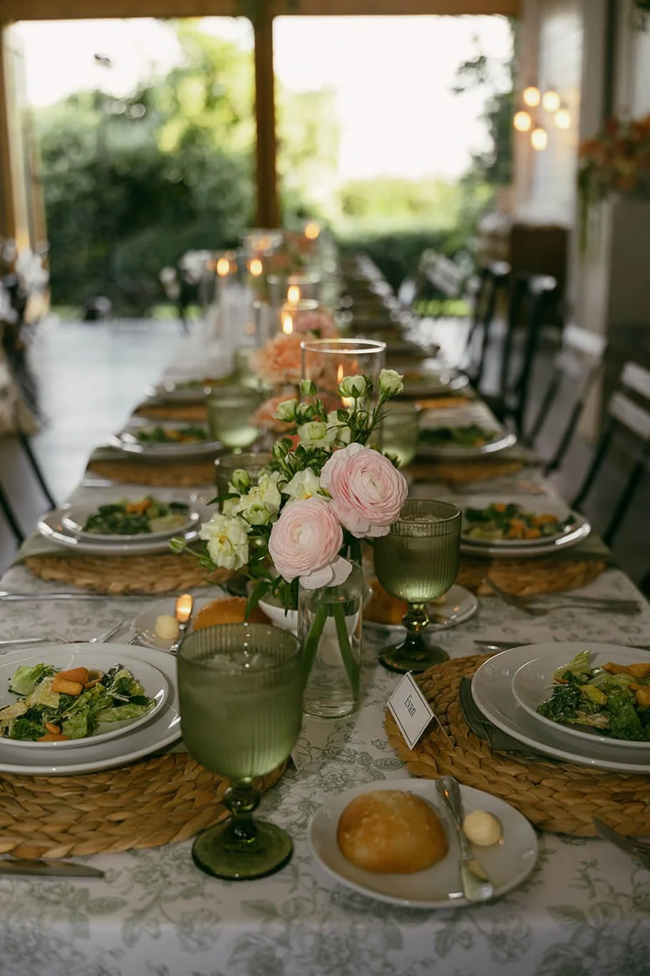 Banquet table set with flowers, glasses, and plates