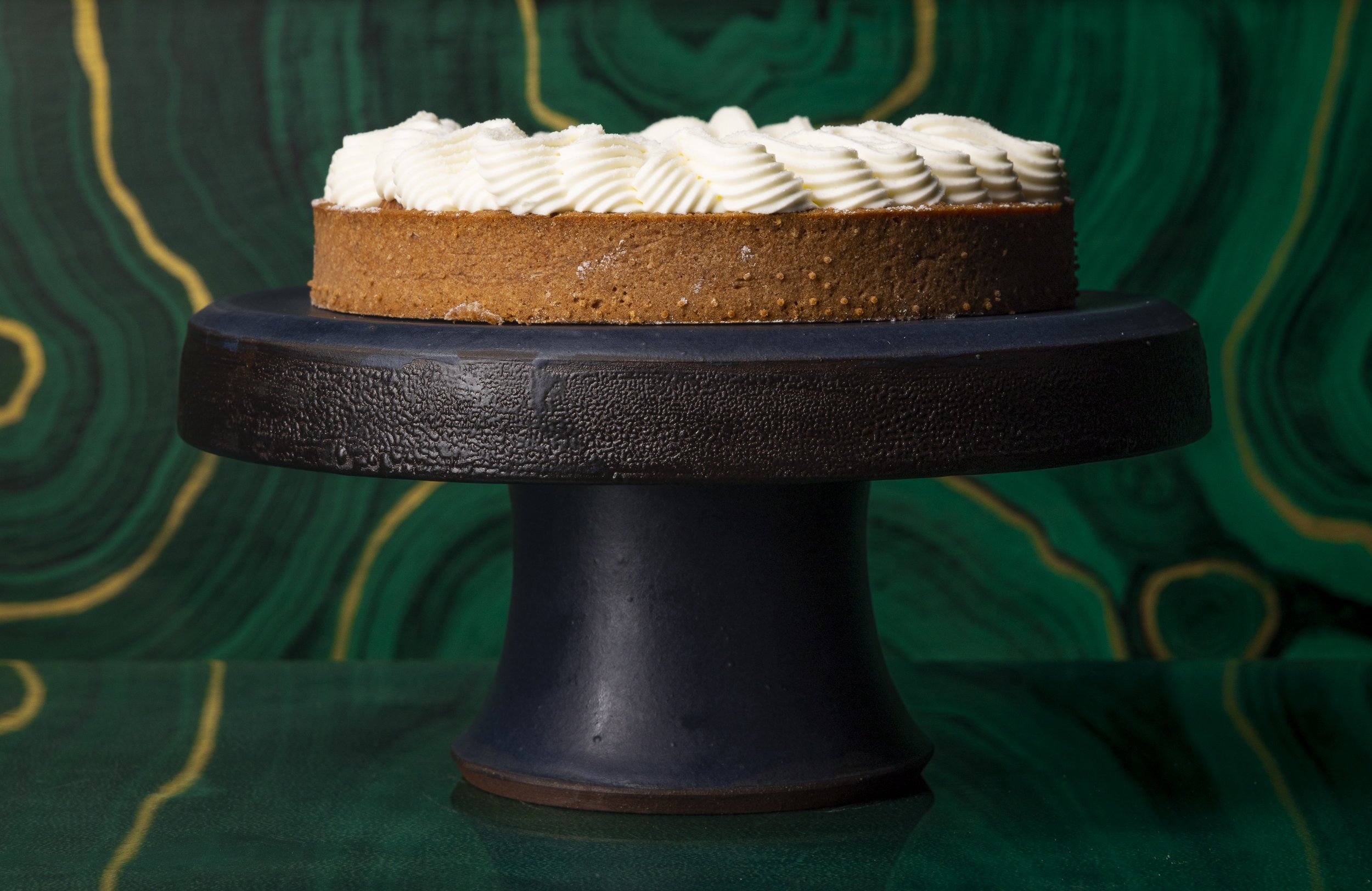 ink texture cake stand with white frosted cake