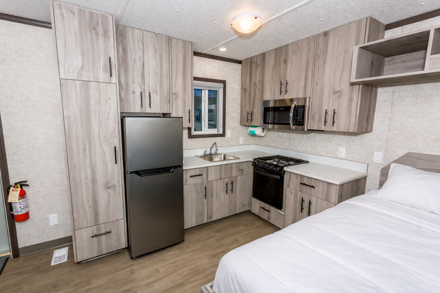 Compact studio with modern kitchen and bed.png