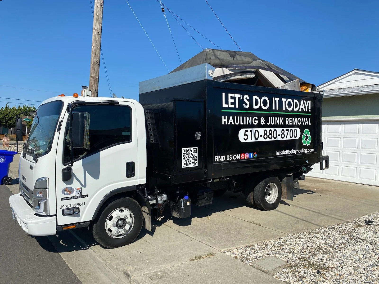 Let's Do It Today junk removal truck parked in a Bay Area driveway