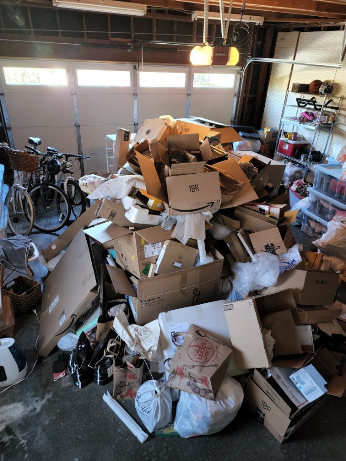 Cluttered garage full of boxes and household items in need of junk removal