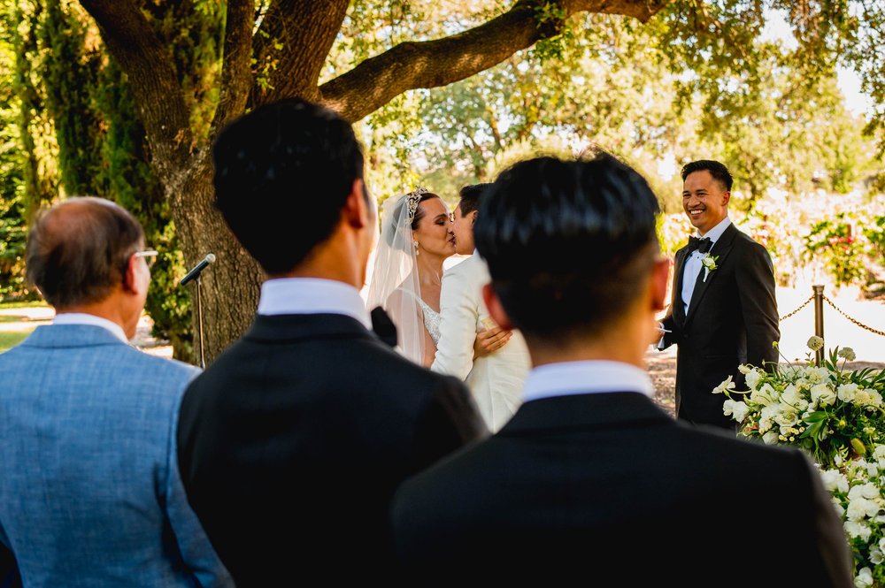 bride and groom kissing during the ceremony